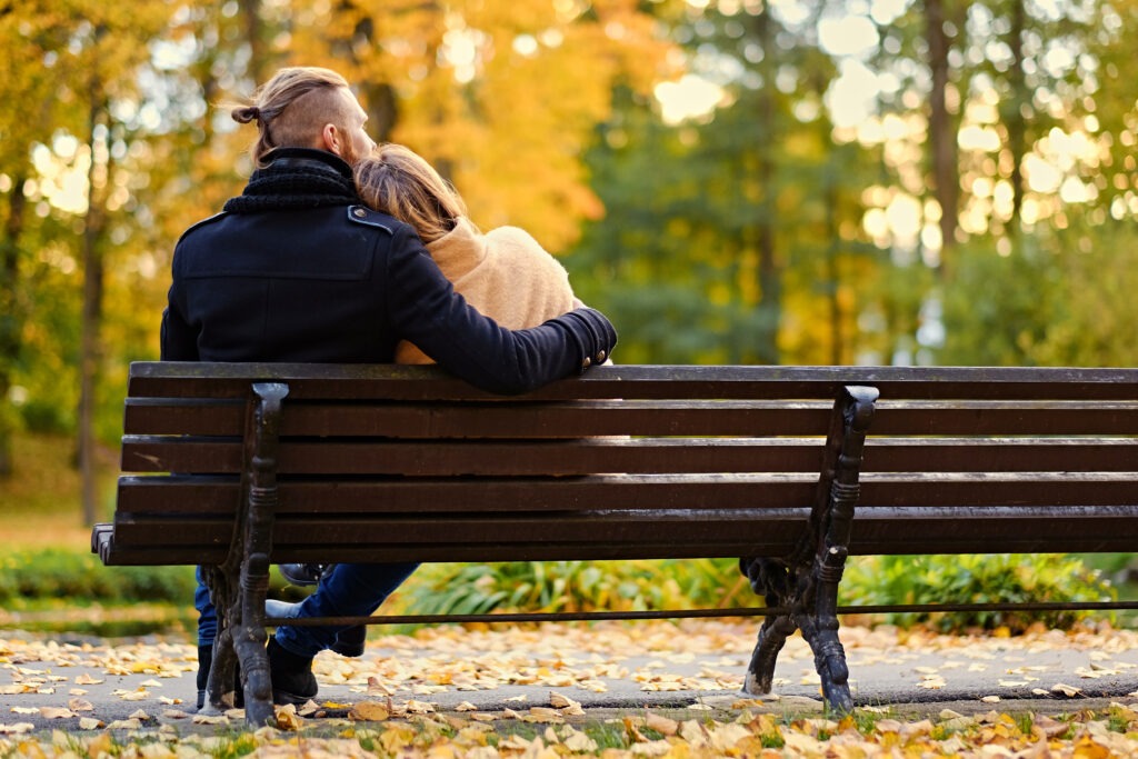 Couple sharing a peaceful moment on a park bench.